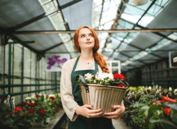 A woman holding a bucket of flowers