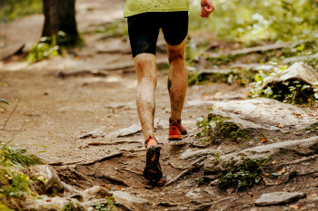 Athlete runner at a forest trail